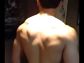 Young Asian man showing off his muscles.