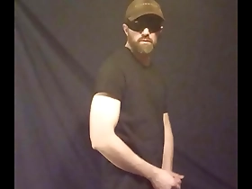 Half-naked gay man enjoying solo pleasure with ball strap tease