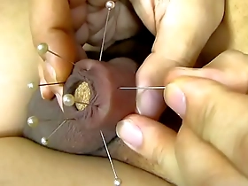 Japanese soloboy enjoys pain as his foreskin is pierced with a needle.