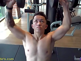 A handsome Asian man prepares himself in the gym for nipple play.