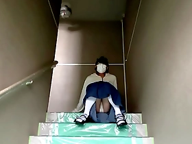 Mayu Konka takes a selfie of her pantyhose on the stairs of her apartment.