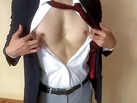 A gay Japanese man masturbates while wearing a suit.