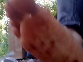Dirty feet with chocolate and ketchup in Nike Air Force 1 sneakers, walking in the park and the streets.