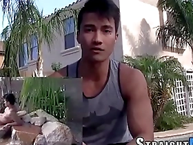 Muscular Asian man masturbating on camera.