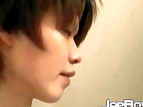 A young Japanese man masturbates with his buttocks spread open.