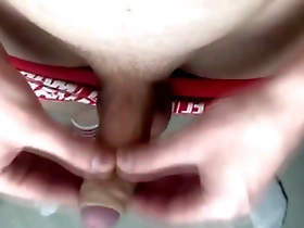 The crimson-clad lad indulges in self-pleasure, vocalizing his intense satisfaction