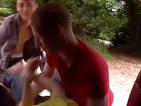 Young AJ and Mark spit roast cute twink Cory in outdoor group sex scene