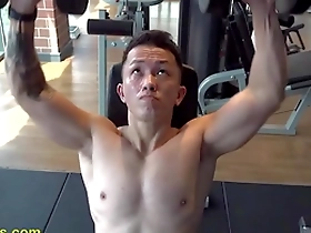 A handsome Asian man getting fit in the gym before a nipple play session.